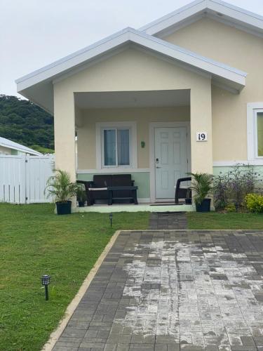 a house with a piano in the front yard at Natalia’s Sweet Oasis in Lucea