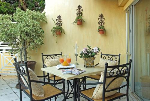 a table with chairs and oranges on a patio at Anchor's Rest Guesthouse and Self Catering in Durban