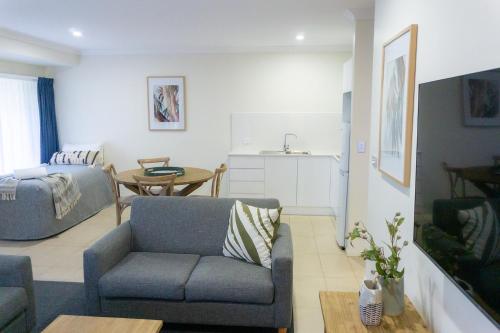 a living room with a couch and a table at Port Stephens Koala Sanctuary in One Mile