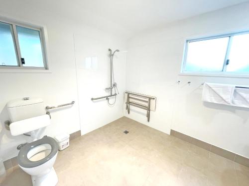 a bathroom with a toilet and a window at Port Stephens Koala Sanctuary in One Mile