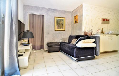 a bedroom with a black leather bed and a desk at Lovely Apartment In Orange With Kitchen in Orange