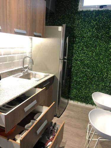 a kitchen with a sink and a green wall at 02 Modern aparment Panamá! Ubicación perfecta pty in Panama City