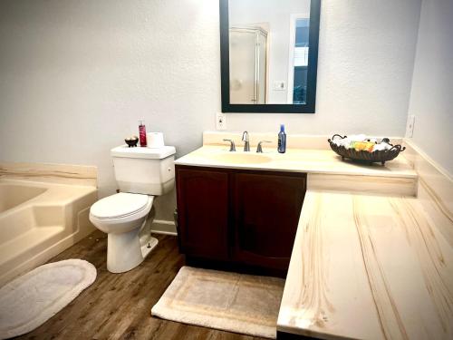 a bathroom with a sink and a toilet and a mirror at Luxurious Bungalow in Payson in Payson