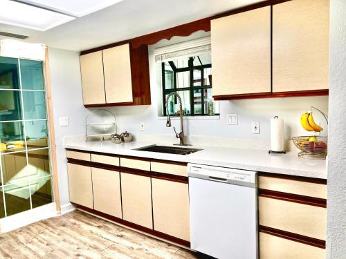 a kitchen with white counters and wooden cabinets at Luxurious Bungalow in Payson in Payson