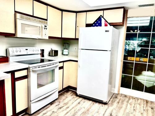 a kitchen with a white refrigerator and a stove at Luxurious Bungalow in Payson in Payson