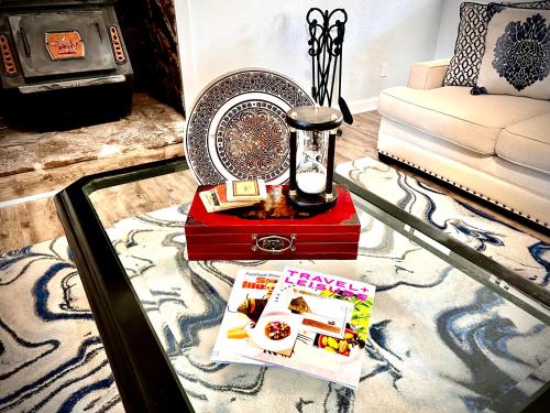 a coffee table with a book and a lamp and a magazine at Luxurious Bungalow in Payson in Payson