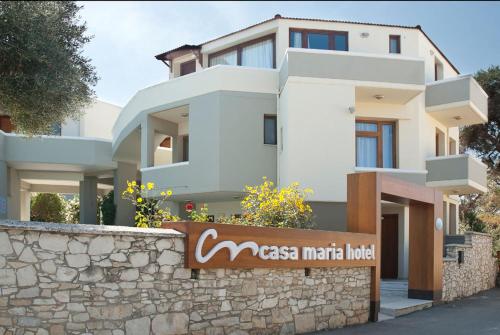 
a building with a sign on the side of it at Casa Maria Hotel Apts in Platanias
