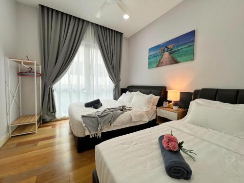 a bedroom with two beds and a window at Maison life 小居屋 The Loft Imago in Kota Kinabalu