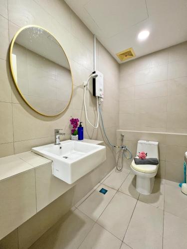 a bathroom with a sink and a mirror and a toilet at Maison life 小居屋 The Loft Imago in Kota Kinabalu