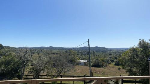 a view of the hills from the deck of a house at Cabaña Sol y Luna in Villa Serrana