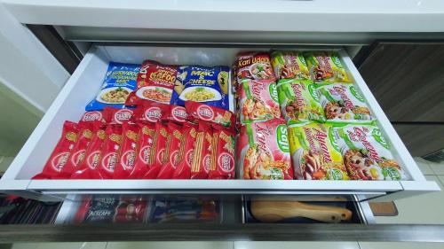 a refrigerator filled with lots of bags of food at New Modern Condo with Pool at Bangi in Kampong Tangkas