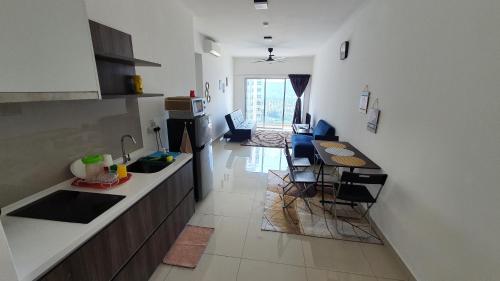 a kitchen with a counter and a table in a room at New Modern Condo with Pool at Bangi in Kampong Tangkas