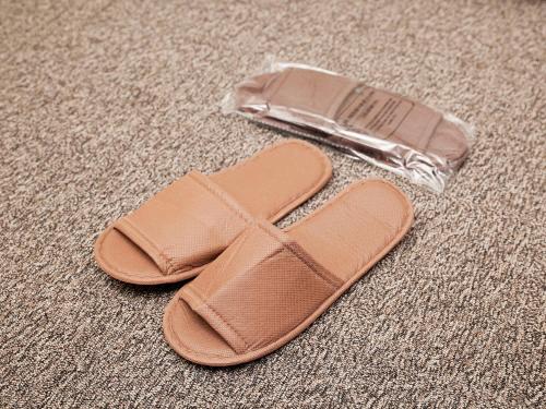 a pair of sandals and a plastic bag on the floor at Hotel Route Inn Osaka Izumifuchu in Izumi