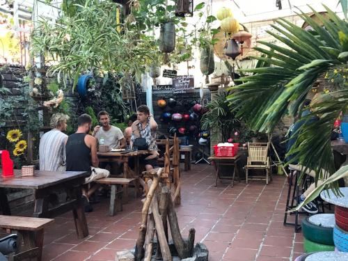 a group of people sitting at tables in a restaurant at Redhouse Dalat Hotel in Da Lat