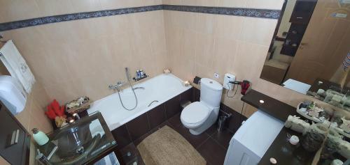 a bathroom with a tub and a toilet and a sink at Aphrodite View in Korakiaí