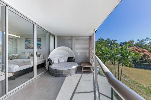 a bedroom with two beds on a balcony at Candlelight - Airlie Beach in Airlie Beach
