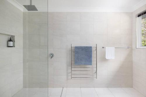 a bathroom with a shower with a blue towel at Deja Blue in Anna Bay