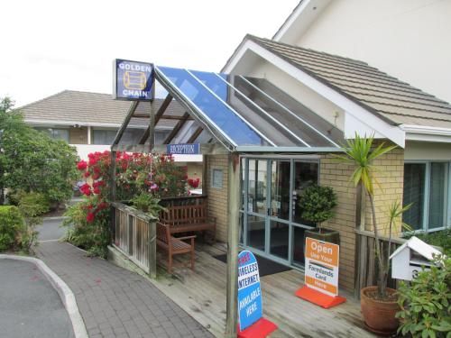 a house with a solarium on the front of it at Fenton Court Motel in Rotorua