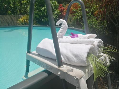 a swing with towels and a swan next to a swimming pool at Bed & Breakfast To-Co in Sichon