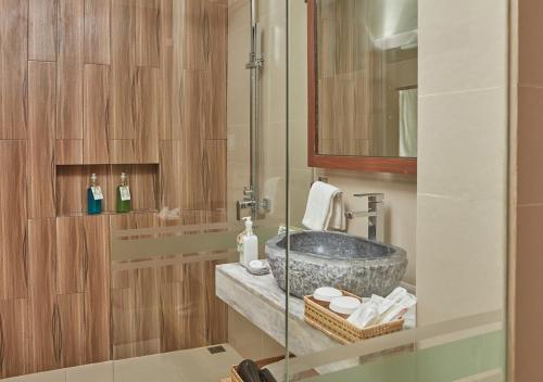 a bathroom with a sink and a mirror at Tag Resort in Coron