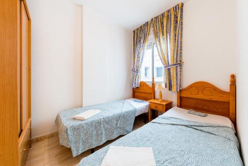 um quarto com duas camas e uma janela em Apartamento Céntrico Tomillo em Torrevieja