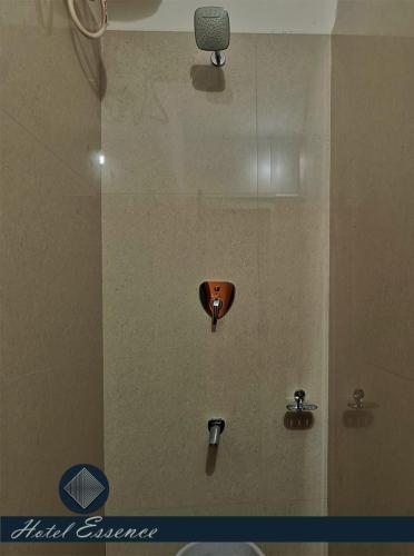 a bathroom with a shower with a toilet at Hotel ESSENCE in Vellore