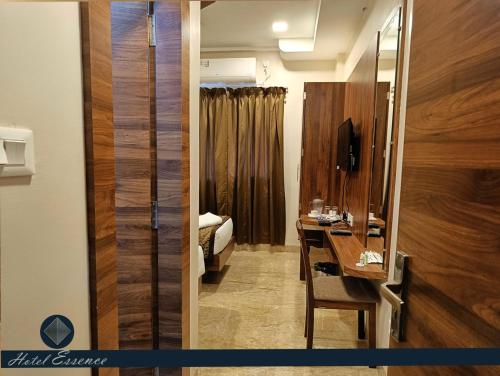 a bathroom with a sink and a mirror in a room at Hotel ESSENCE in Vellore