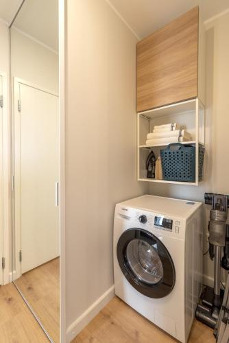 a laundry room with a washer and dryer at Artisa Riia Str 20a Luxury 2BR Penthouse Apartment in Tartu