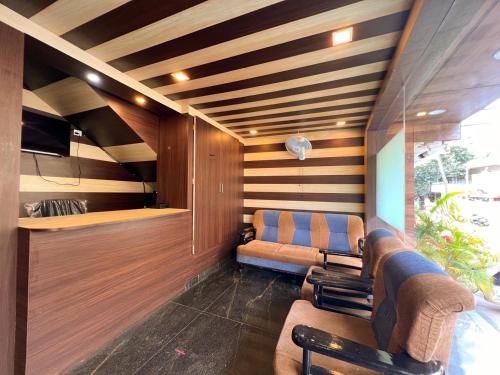 a living room with two couches and wooden walls at Hotel InTourist by Agira Hotel in Bengaluru