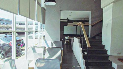 a staircase in a building with a car parked in a parking lot at Jpark Residences at Thammasat Rangsit in Ban Bang Phut (3)