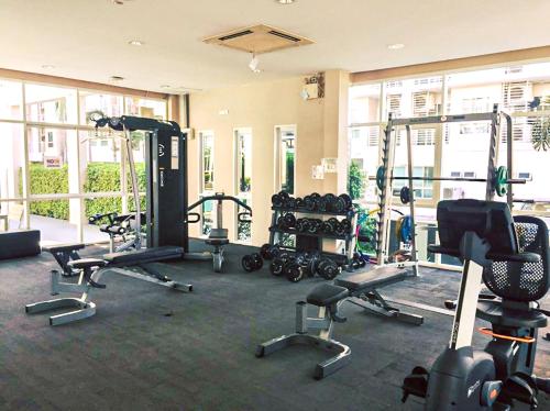 a gym with several treadmills and machines in a room at Jpark Residences at Thammasat Rangsit in Ban Bang Phut (3)