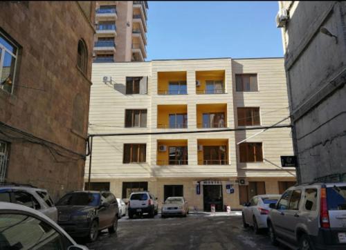 a building with cars parked in front of it at Loft Host Yerevan in Yerevan