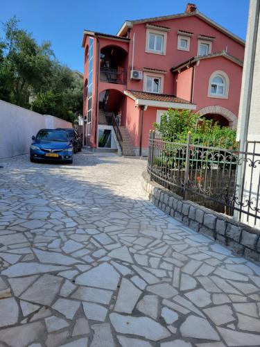 a car parked in front of a house at Apartments Bogdanovic in Kotor