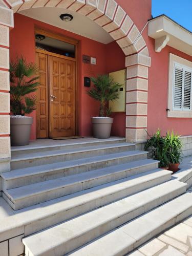 a house with stairs leading to a door at Apartments Bogdanovic in Kotor