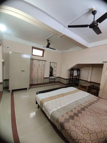 a bedroom with a bed and a ceiling fan at Madrid Homes in Guwahati