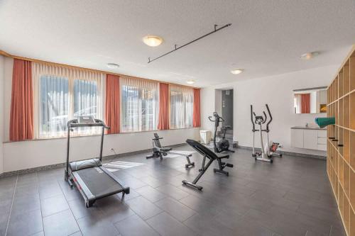 a gym with several exercise equipment in a room at Aktiv- und Genusshotel Alpenblick in Fiesch