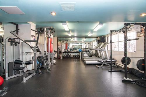 a gym with several treadms and machines in it at Sandman Suites Vancouver on Davie in Vancouver