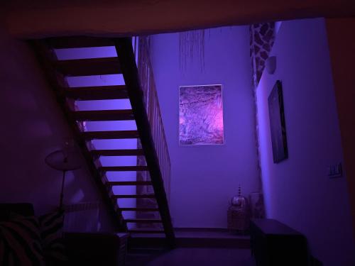 a purple room with a staircase with a purple light at Mata Hari in Inogés