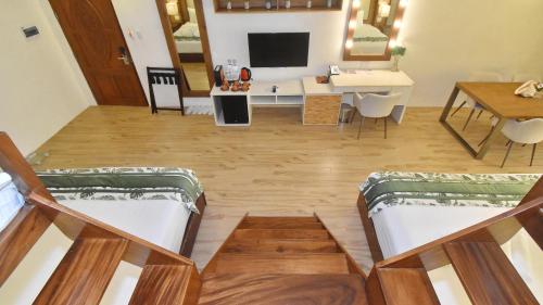 a living room with two beds and a table at Ambassador In Paradise in Boracay