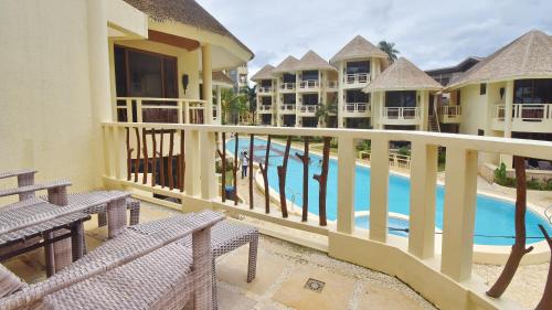 a view of a pool from the balcony of a resort at Ambassador In Paradise in Boracay