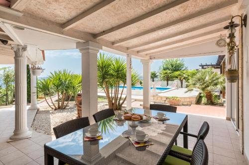 a dining room with a table and chairs on a patio at Holiday Home Split in Split