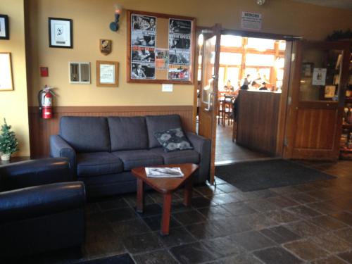 a living room with a couch and a table at Howe Sound Inn & Brewing Company in Squamish