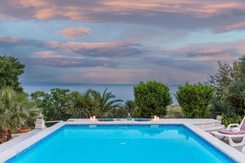 a swimming pool in a yard with a sky at Holiday Home Split in Split
