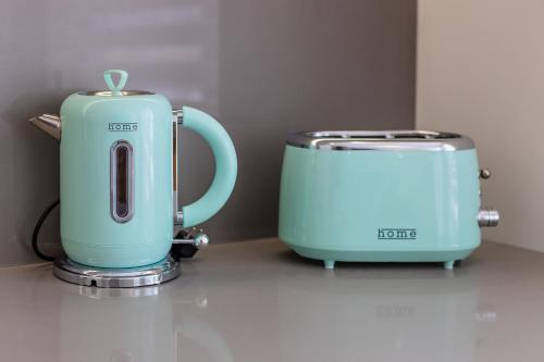 two toasters sitting on a counter next to each other at Pestana Apartments - Premium in Porto