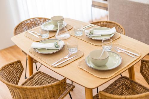a wooden table with plates and dishes on it at Pestana Apartments - Premium in Porto