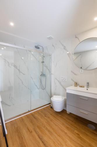 a bathroom with a shower and a toilet and a sink at Pestana Apartments - Premium in Porto