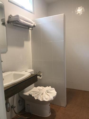 W łazience znajduje się umywalka, toaleta i lustro. w obiekcie Koh Yao Yai Sea Breeze House เกาะยาวใหญ่ซีบรีซเฮ้าส์ w mieście Ko Yao Yai