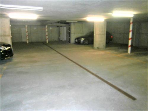 an empty parking garage with a car parked in it at Le Sapin in Les Diablerets