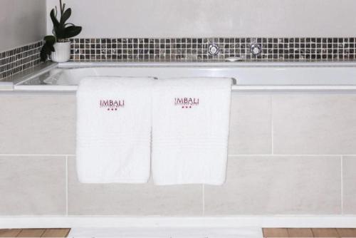 two towels on a counter in a bathroom at Imbali Boutique Hotel in Kokstad