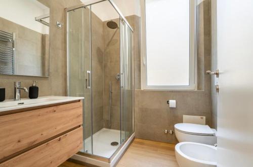 a bathroom with a shower and a toilet and a sink at Testaccino Case vacanze in Rome